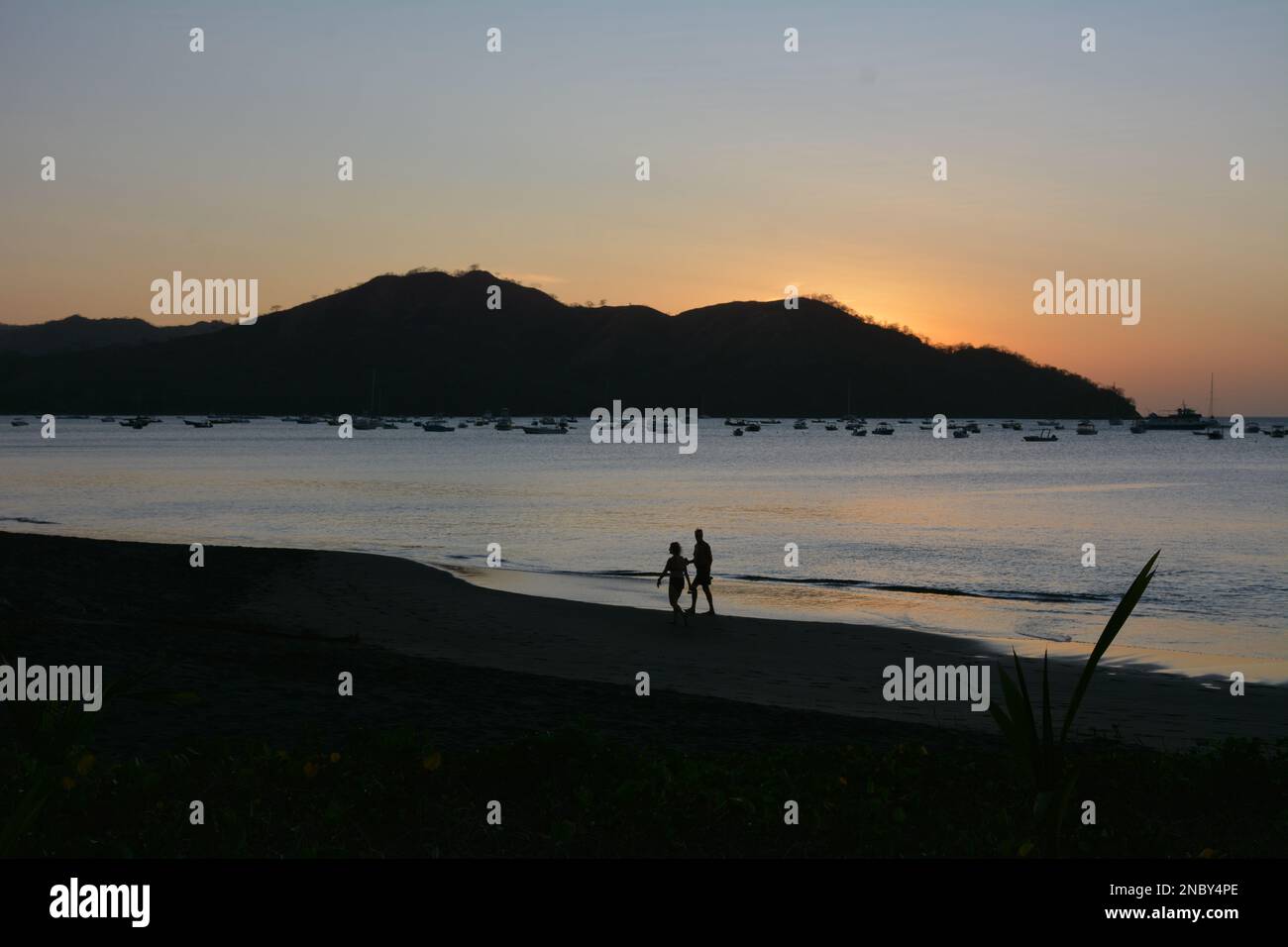 People on beach at sundown on Playa Coco in Costa Rica Stock Photo