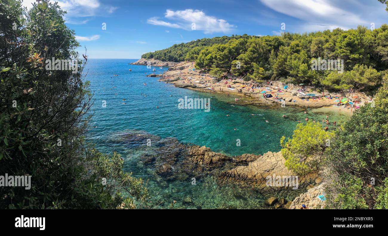 Pula, Croatia - August 20, 2022: Beautiful Sunny Panorama of Beach during Summer Day. European Bay with Turquoise Adriatic Sea. Stock Photo