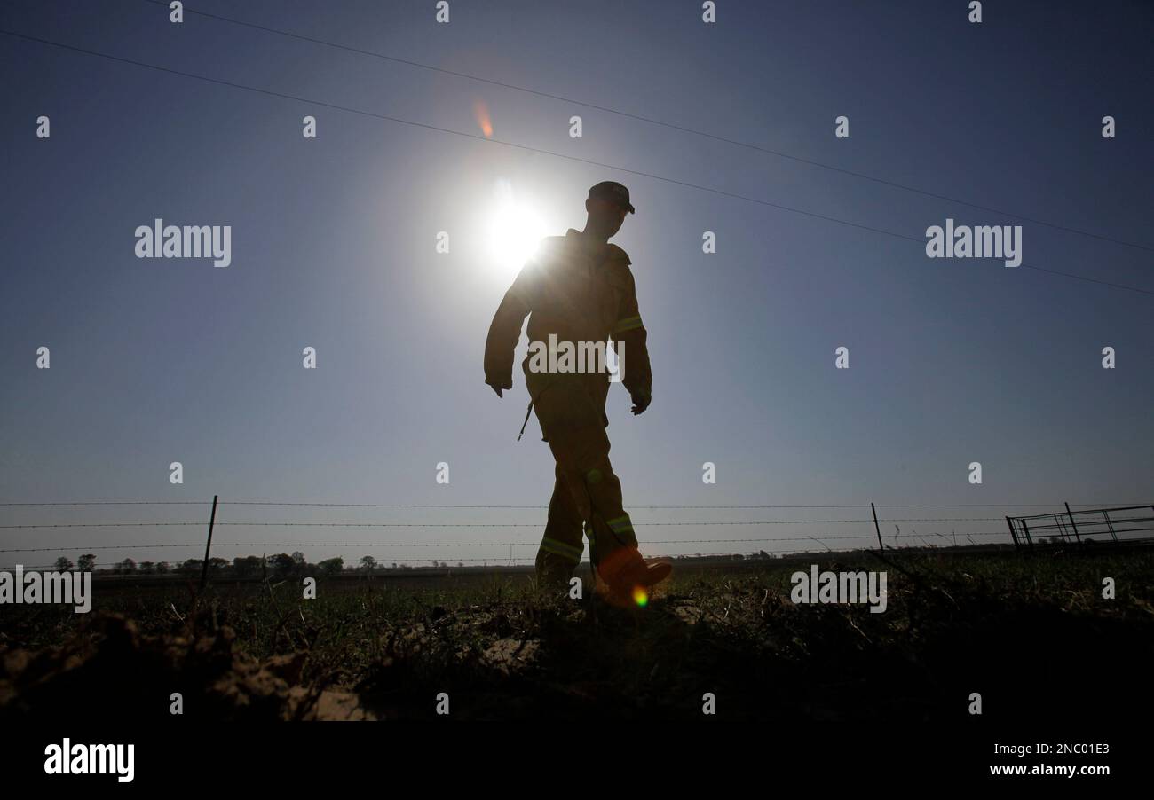 Roger Rutledge Volunteer firefighter Roger Rutledge stomps on a hot spot in a burned ...