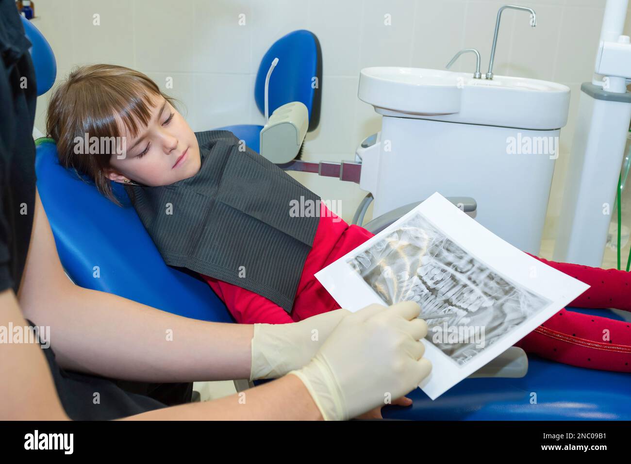 A dentist and a child patient are looking on dental X-rays Stock Photo ...