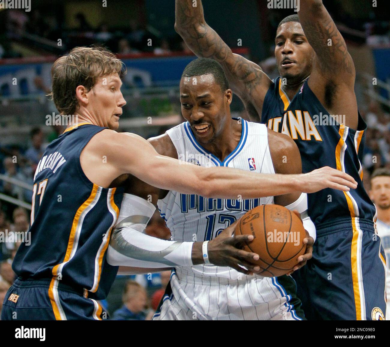 Orlando Magic's Dwight Howard, center, tries to find an opening to the