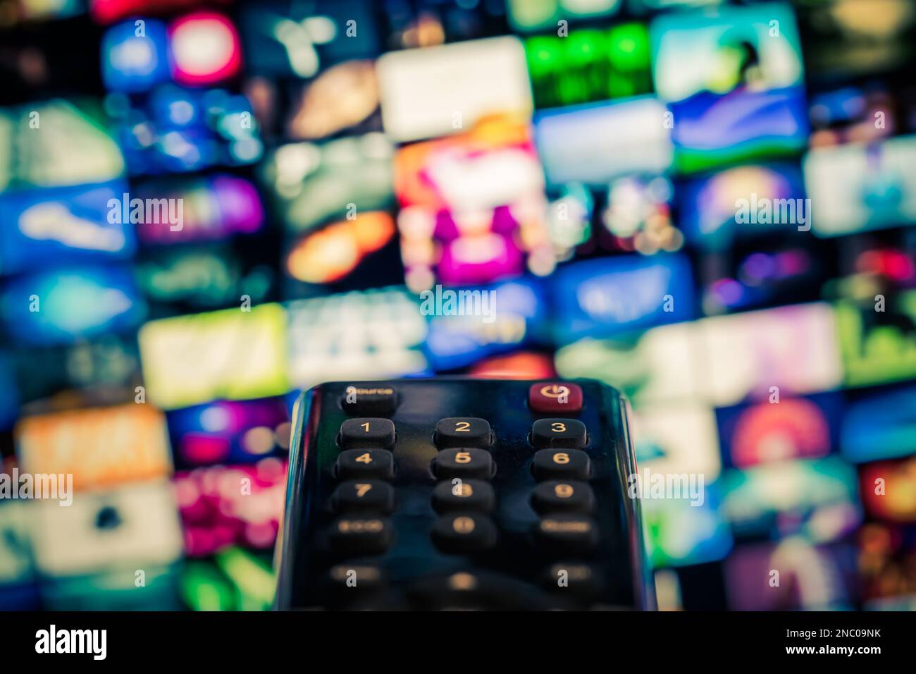 Video on demand (VoD) screen with remote control in foreground Stock Photo