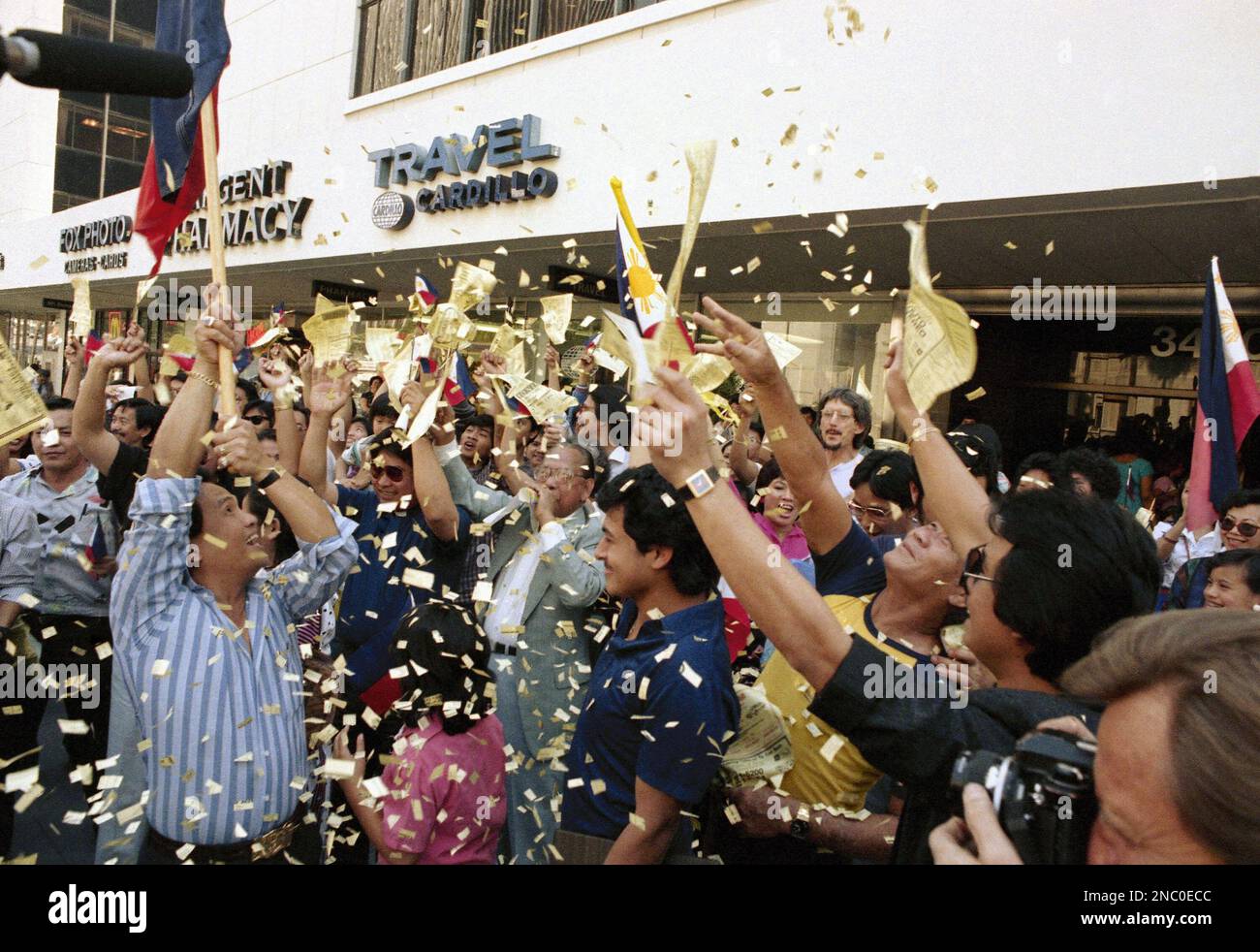 Chanting and waving signs, a jubilant crowd gathers at the Philippine