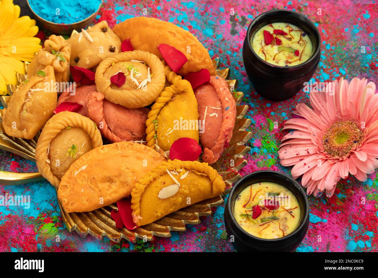 Indian Festival Of Colors Holi Is Celebrated With Colorful Gulal Abeer, Kesar Pista Badam Thandai, Gujiya, Mawa Potli Gujia, Chandrakala, Mithai, Wate Stock Photo