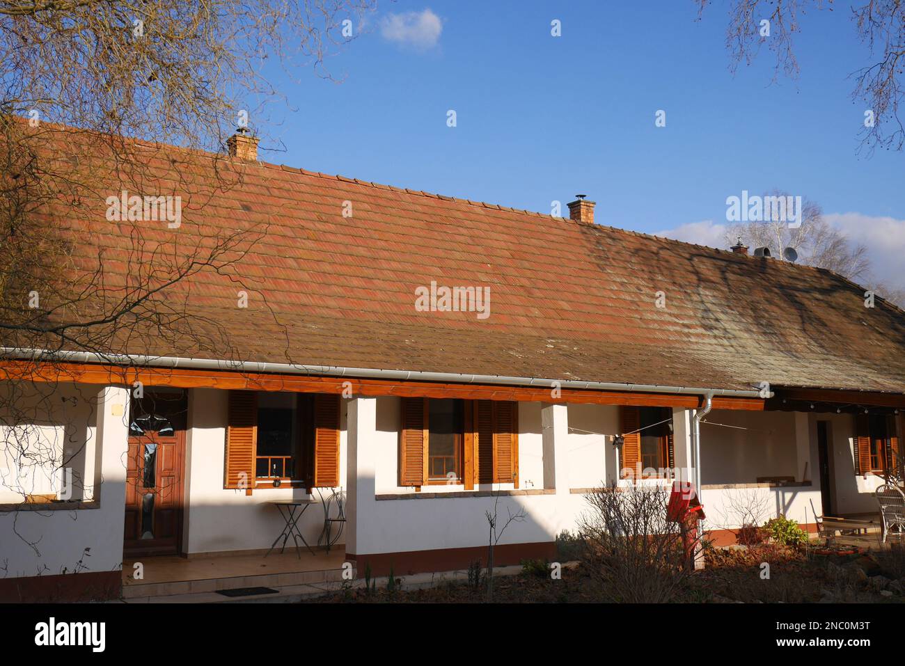 Traditional peasant longhouse, paraszthaz, with open veranda, in a village, Hungary Stock Photo