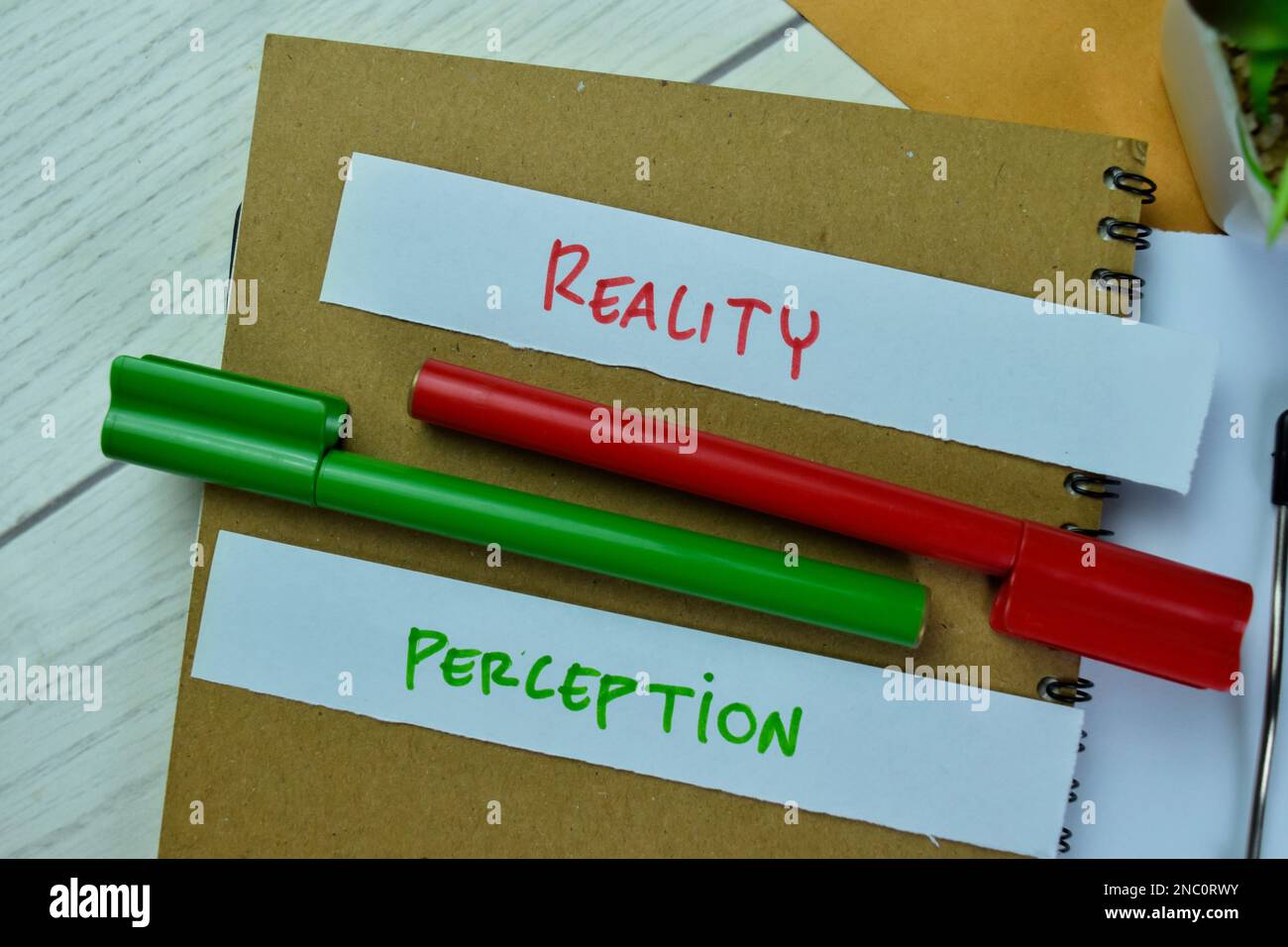 Concept of Reality or Perception write on sticky notes isolated on Wooden Table. Stock Photo