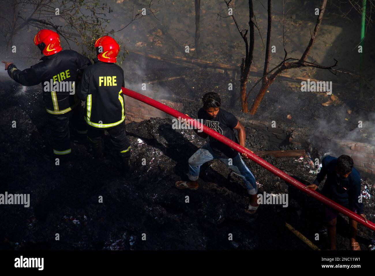 Dhaka, Dhaka, Bangladesh. 14th Feb, 2023. Firefighters try to extinguish a fire at a godown at Mohammadpur in Dhaka, Bangladesh, on February 14, 2023. (Credit Image: © Abu Sufian Jewel/ZUMA Press Wire) EDITORIAL USAGE ONLY! Not for Commercial USAGE! Stock Photo