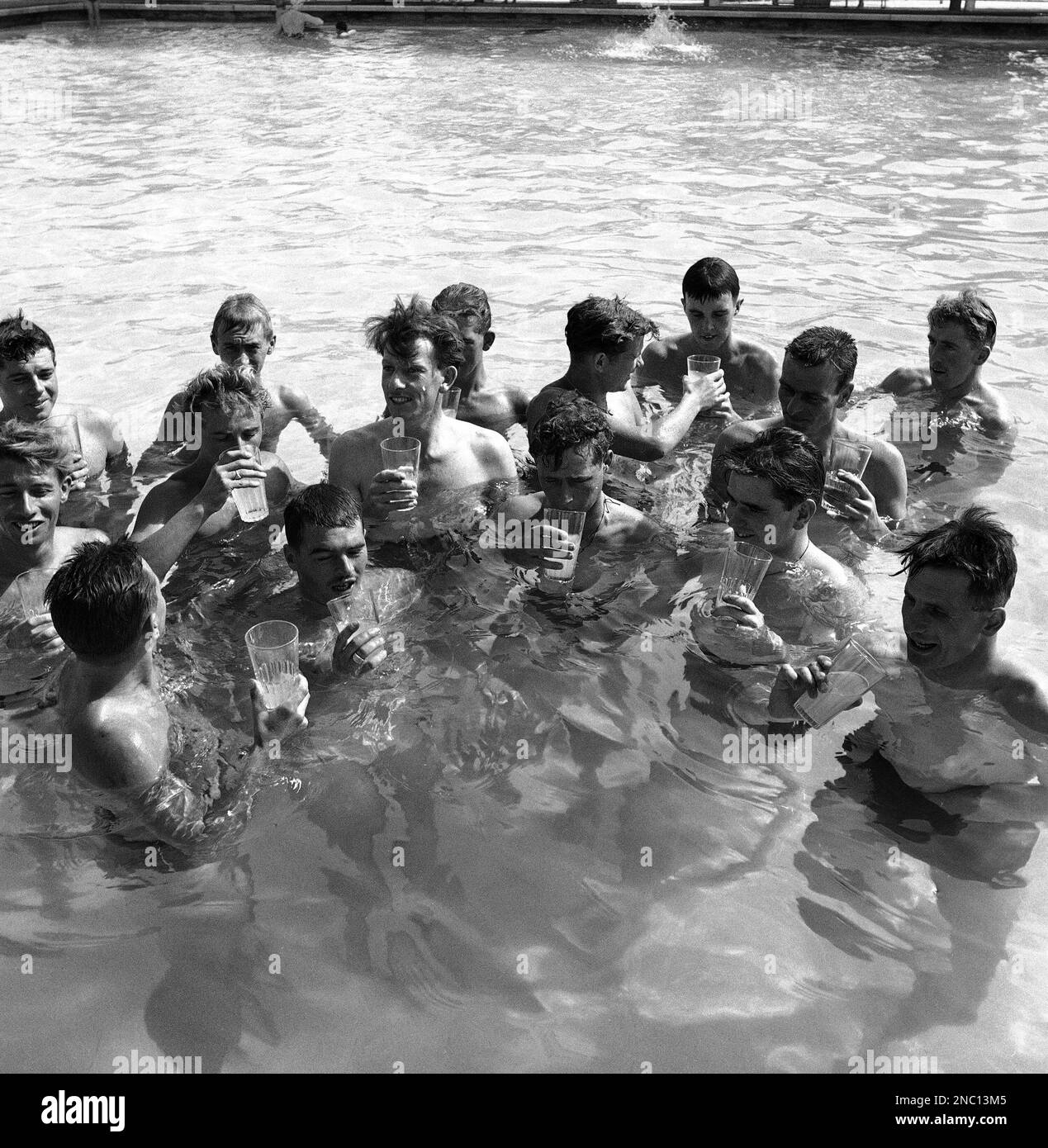 British troops in Kuwait enjoy iced drinks in the swimming pool of the