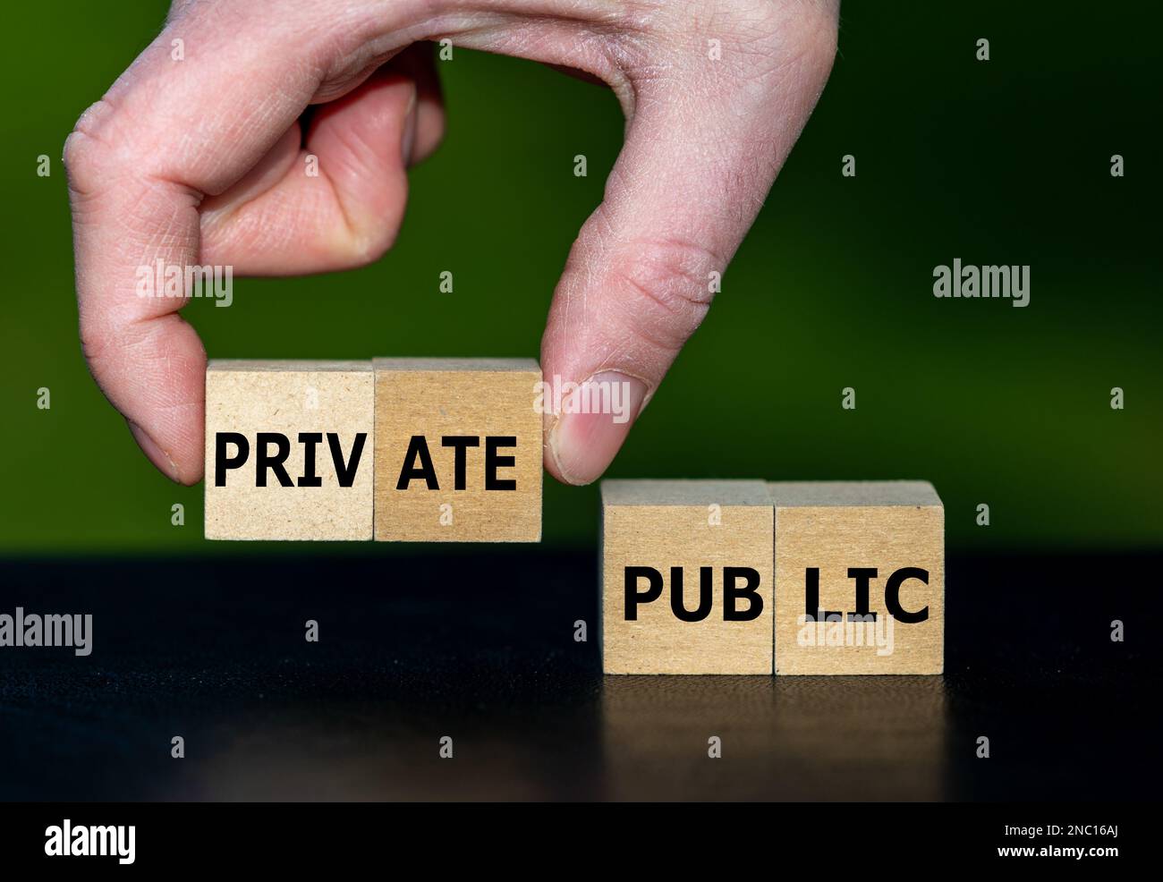 Hand selects cubes with the word private instead of cubes with the word public. Stock Photo