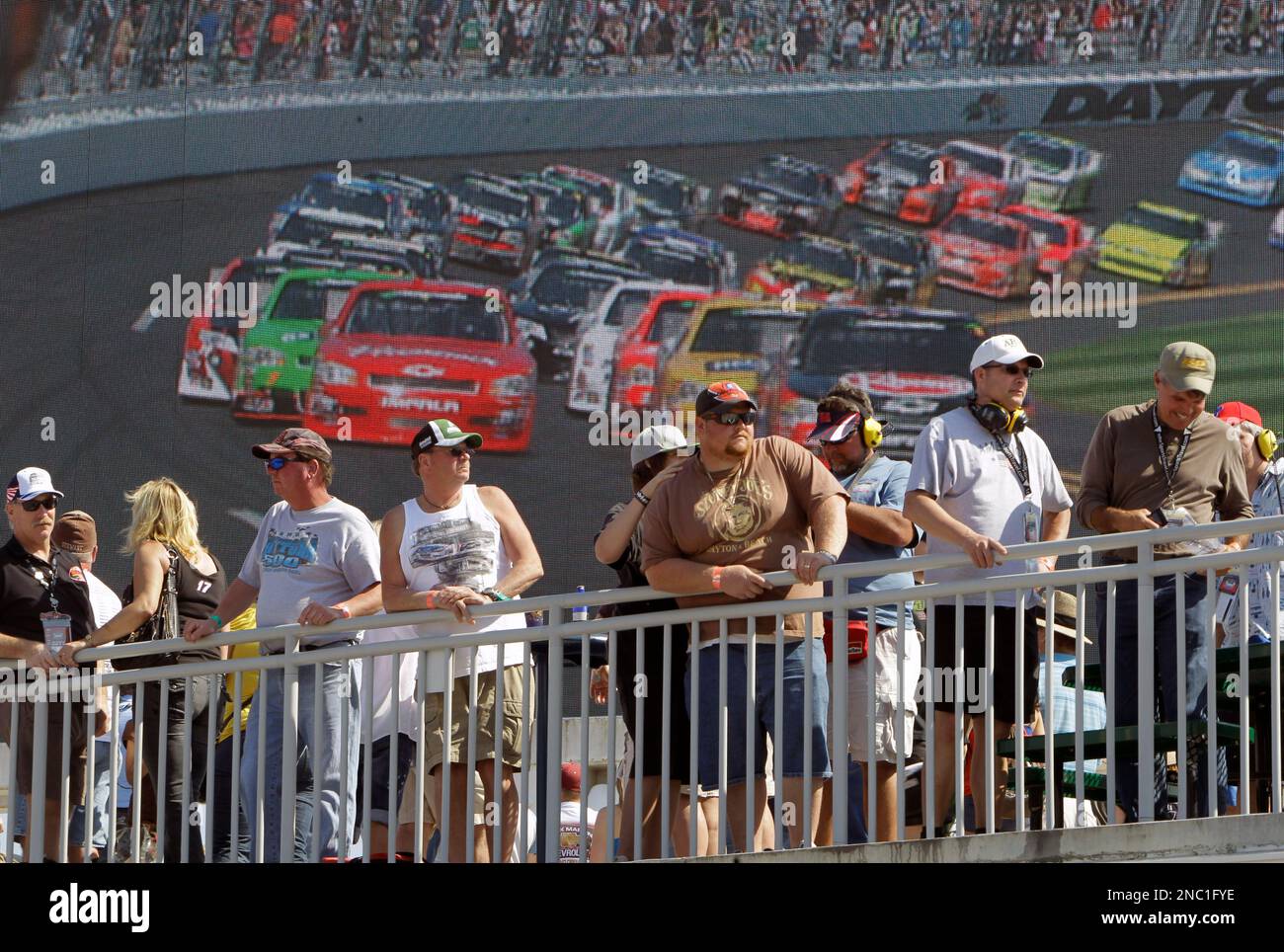 NASCAR race fans watch the DRIVE4COPD 300 auto race in front of a giant