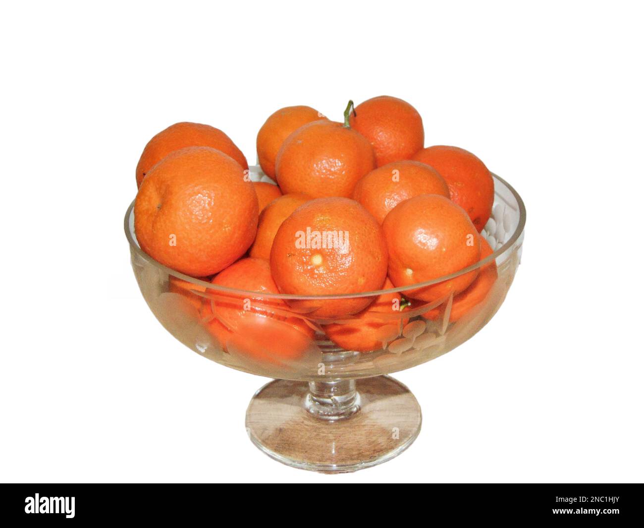 Clementines in a glass bowl. Group of clementines isolated on white