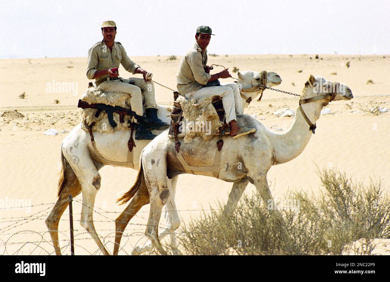 Two Egyptian soldiers, members of the Egyptian border patrol, ride ...