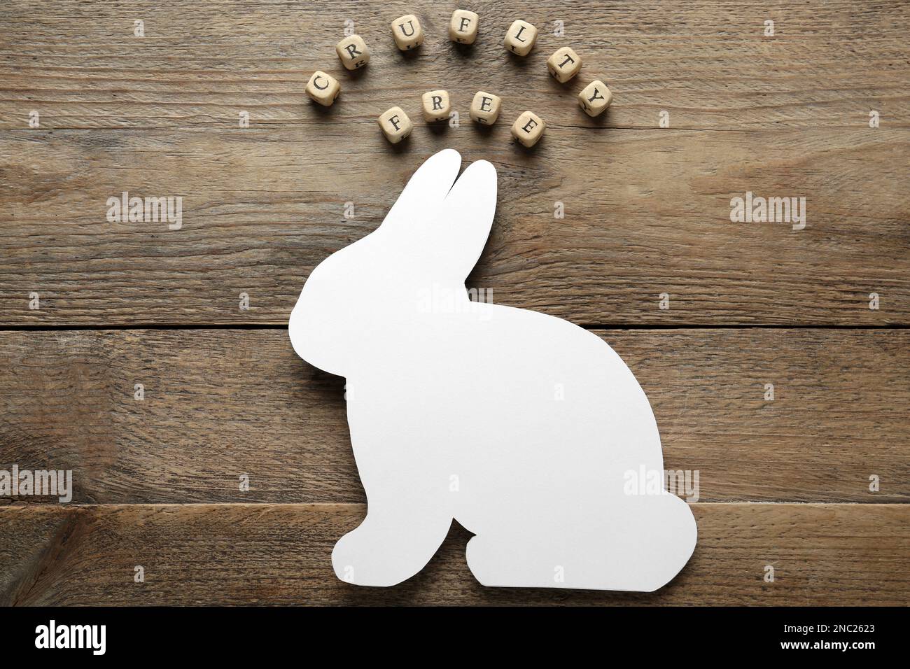 Cubes with text Cruelty Free and figure of rabbit on wooden table, flat lay. Stop animal tests Stock Photo