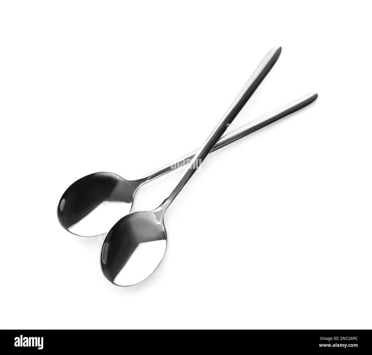 Clean shiny metal spoons on white background Stock Photo Alamy