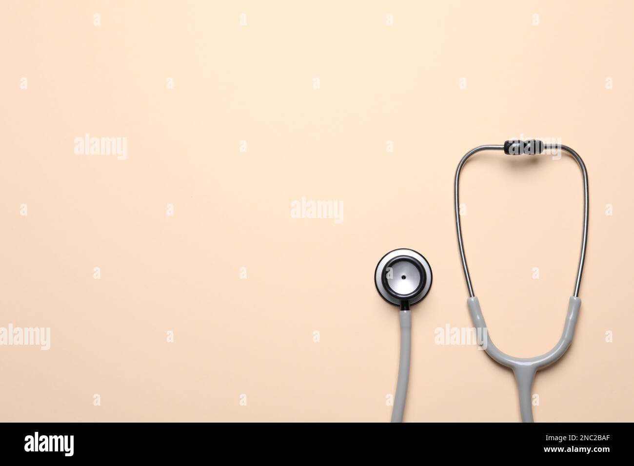 Stethoscope on beige background, top view. Space for text Stock Photo ...