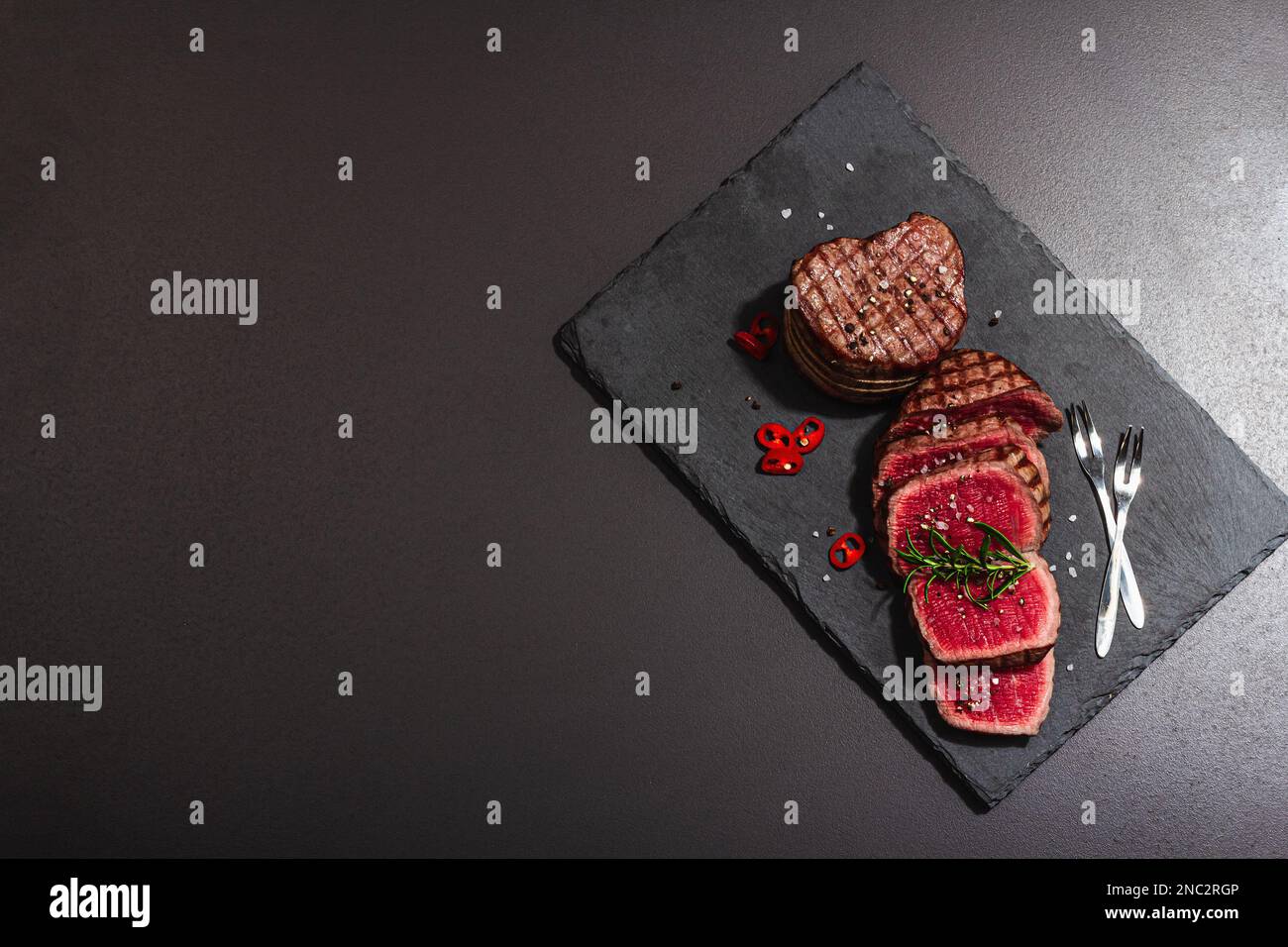 Rare cooking level Eye round steak with spices and herbs. Classic