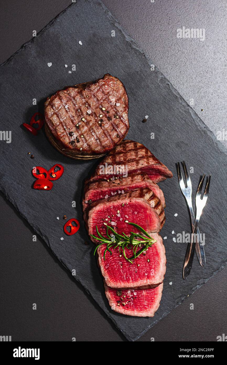 Rare cooking level Eye round steak with spices and herbs. Classic