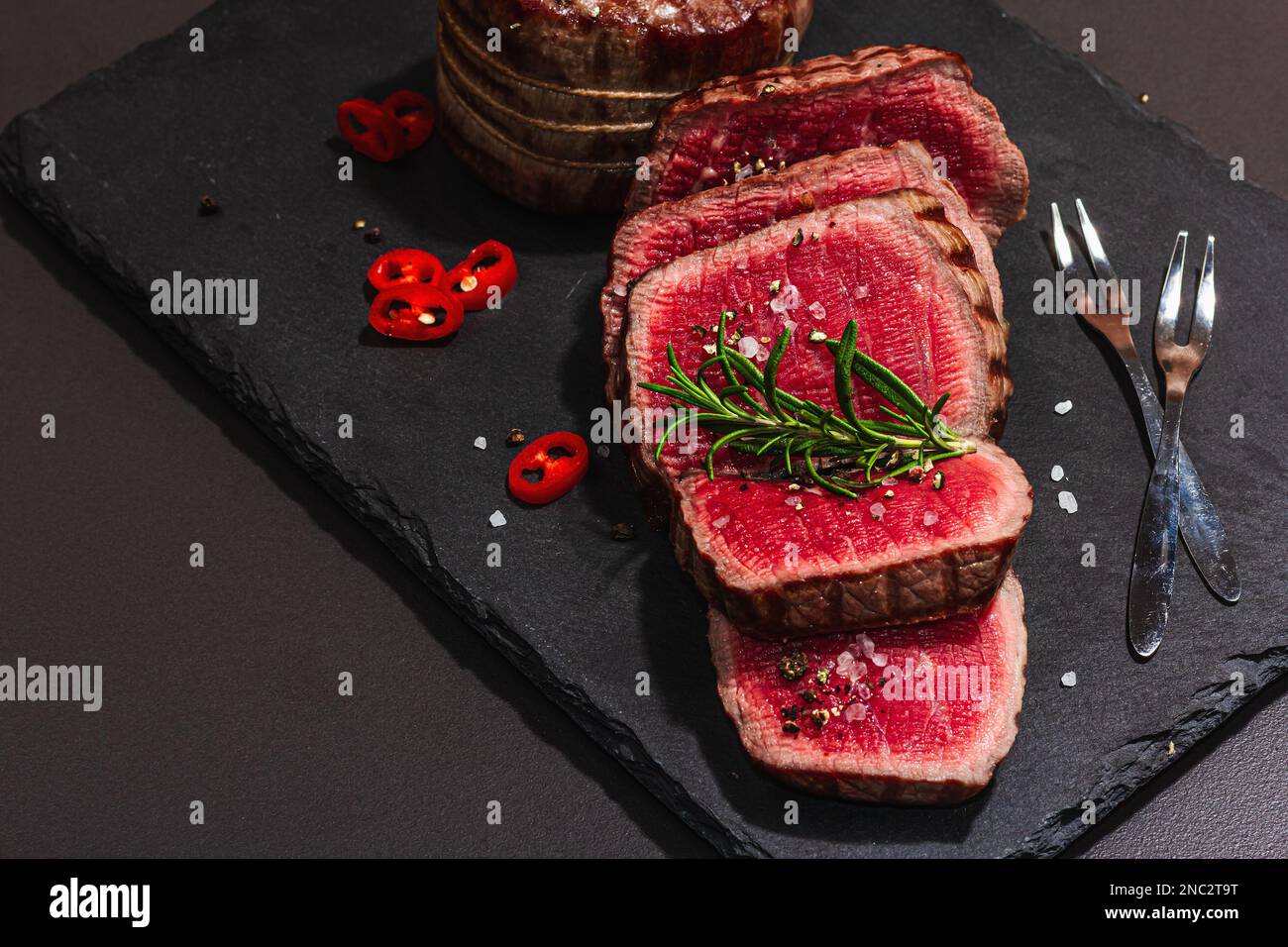 Rare cooking level Eye round steak with spices and herbs. Classic