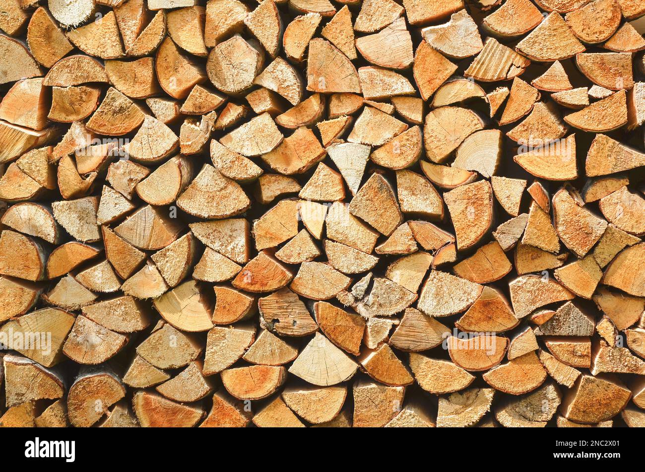 Firewood background. Preparation of firewood for the winter. Pile of firewood. Stock Photo