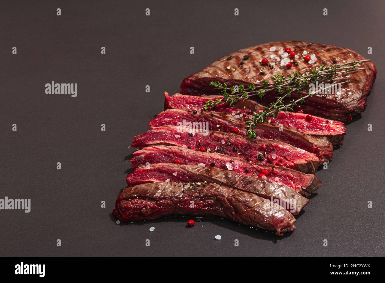 Medium rare Flank steak with spices and herbs. Classic grilled meat cut