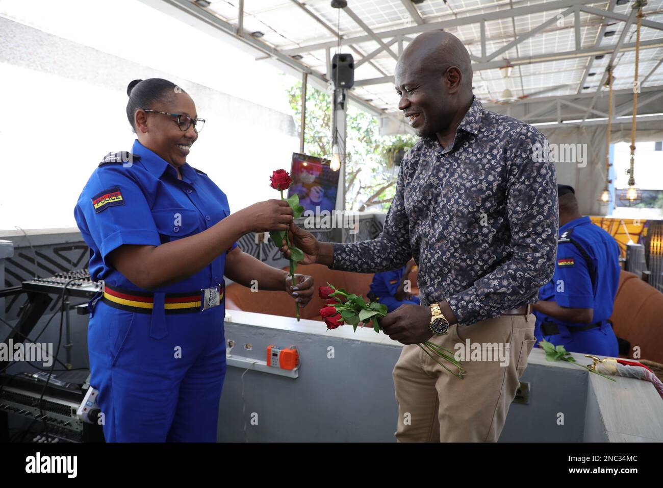 Cafe Deli restaurant owner Obado Obadoh gives deputy OCPD Central Police Station Doris Kimei hands on a flower during Valentine's Day as a token of appreciation for the good work that Kenya Police are doing when it comes to maintaining law and order in the country. Stock Photo