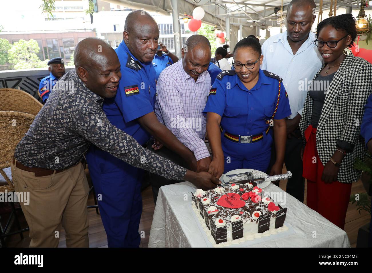 (From L-R) Cafe Deli restaurant CEO Obado Obadoh, Robert Kimilu, sub county commander Central Police Station, Robert Murithi DCIO Central Police Station, Doris Kimei Deputy OCPD Central Police Station cut a cake during the Valentine's Day at Cafe Deli as a token of appreciation to the police. Stock Photo