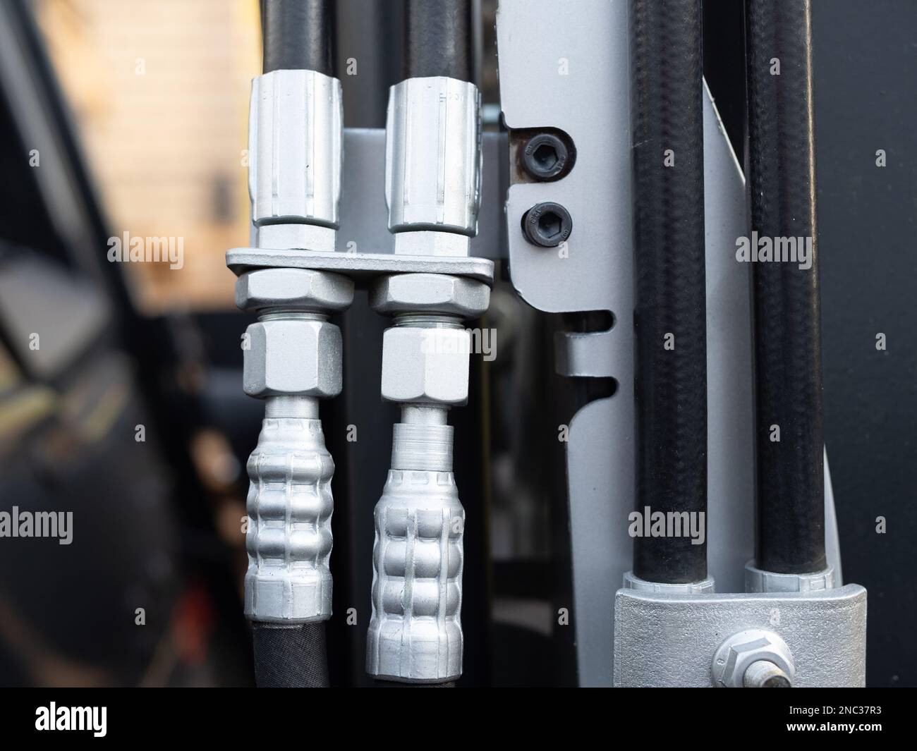 closeup of hydraulic hoses on a fork lift truck and rubber hose connectors Stock Photo