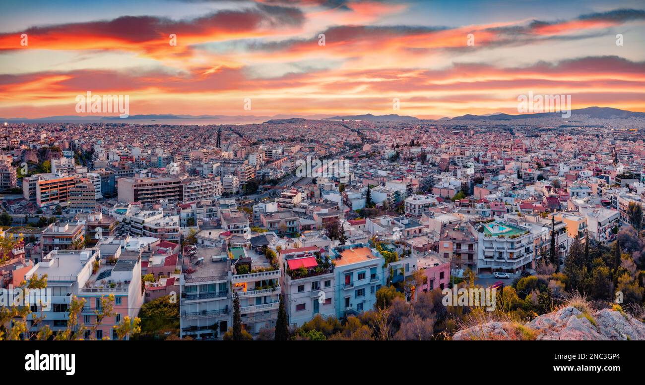 Aerial evening cityscape of Athens. Urban spring scene of Greece, Europe. Splendid sunset in the big sity. Traveling concept background. Stock Photo