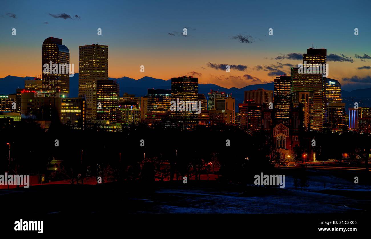 DENVER, COLORADO - FEBRUARY 2023: The beautiful Denver skyline against the warm cast of a winter sunset over the Rocky Mountains. Stock Photo