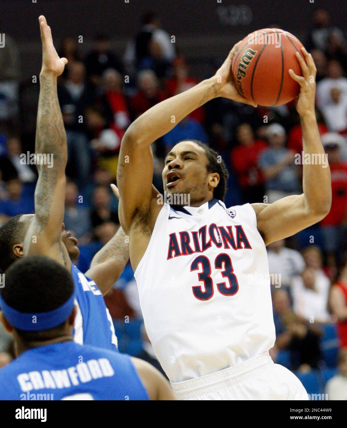 Arizona forward Jesse Perry (33) shoots as Memphis guard Antonio Barton  defends during the first half of a West Regional NCAA tournament second  round college basketball game, Friday, March 18, 2011 in