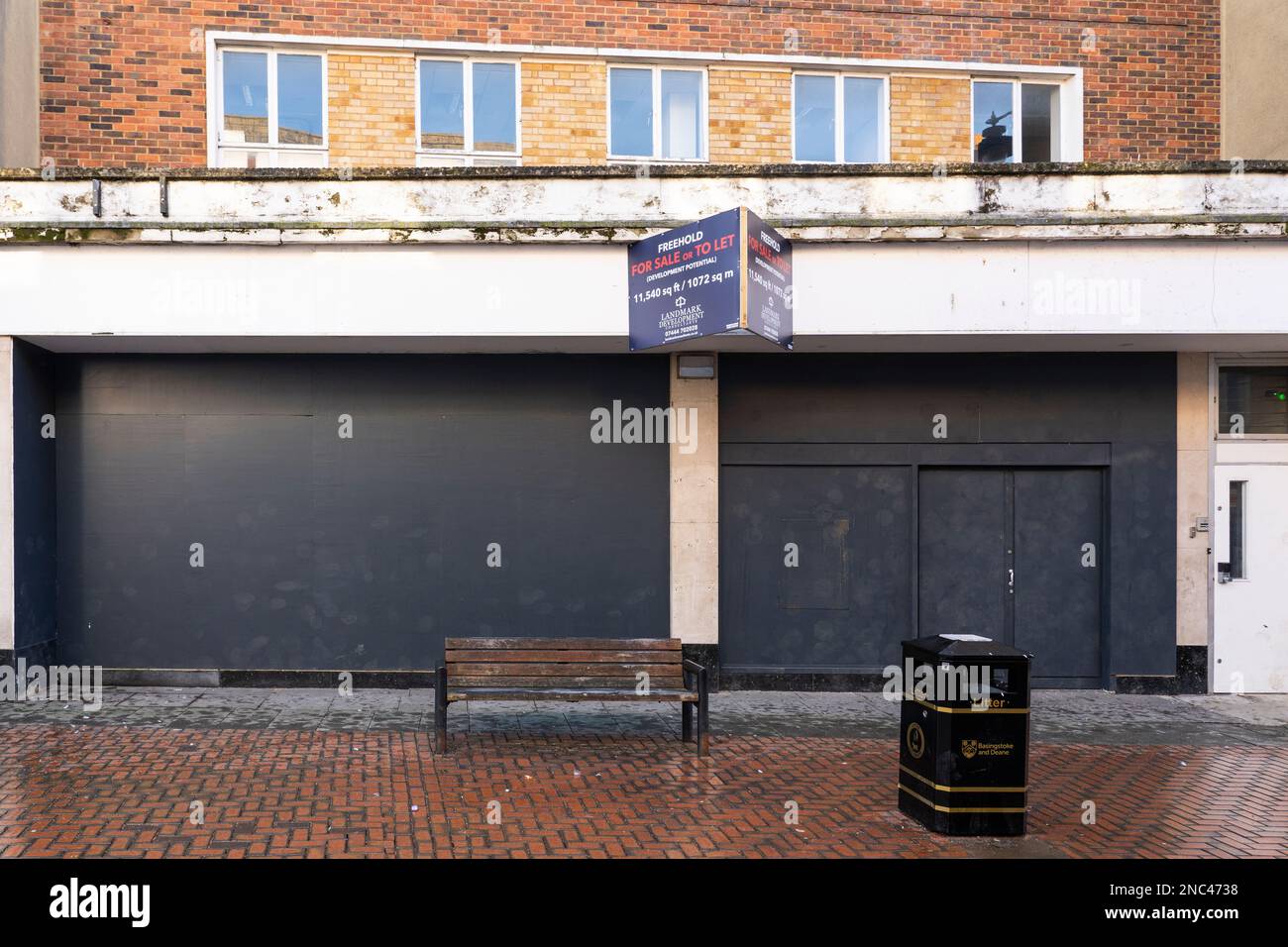 The boarded up disused site of the former post office on London Street in Basingstoke, England. Concept: death of the high street, branch closure Stock Photo