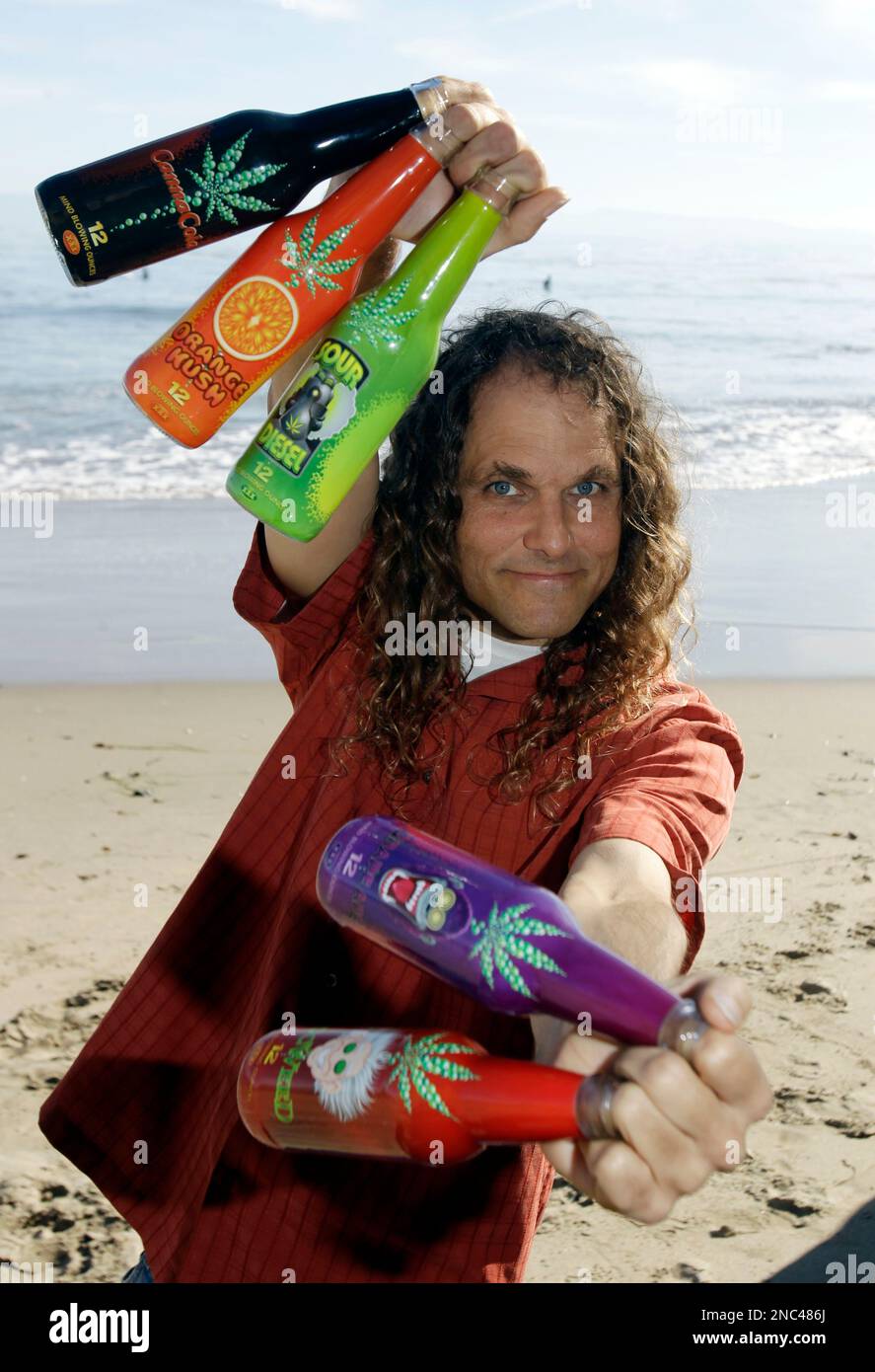 Clay Butler co founder of Canna Cola poses on the beach with his