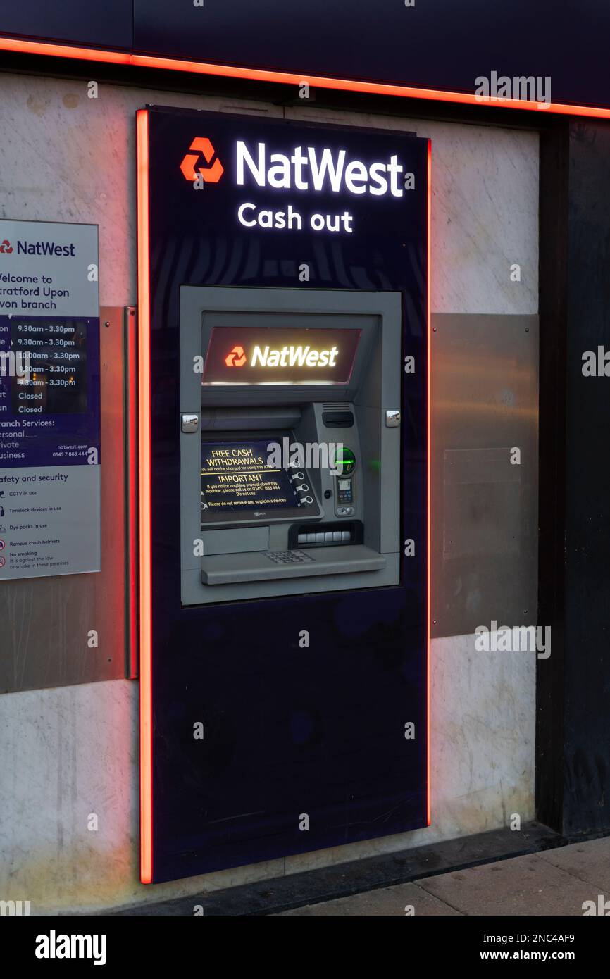 Natwest bank logo and title and a cash machine on the exterior of a