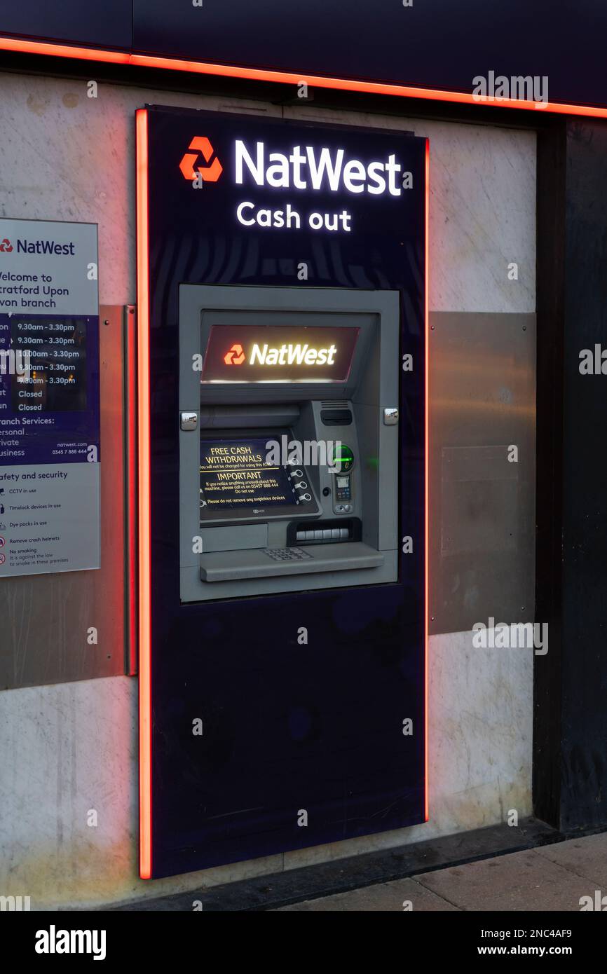 Natwest bank logo and title and a cash machine on the exterior of a high street branch in Stratford upon Avon, UK. Concept: UK banking industry Stock Photo