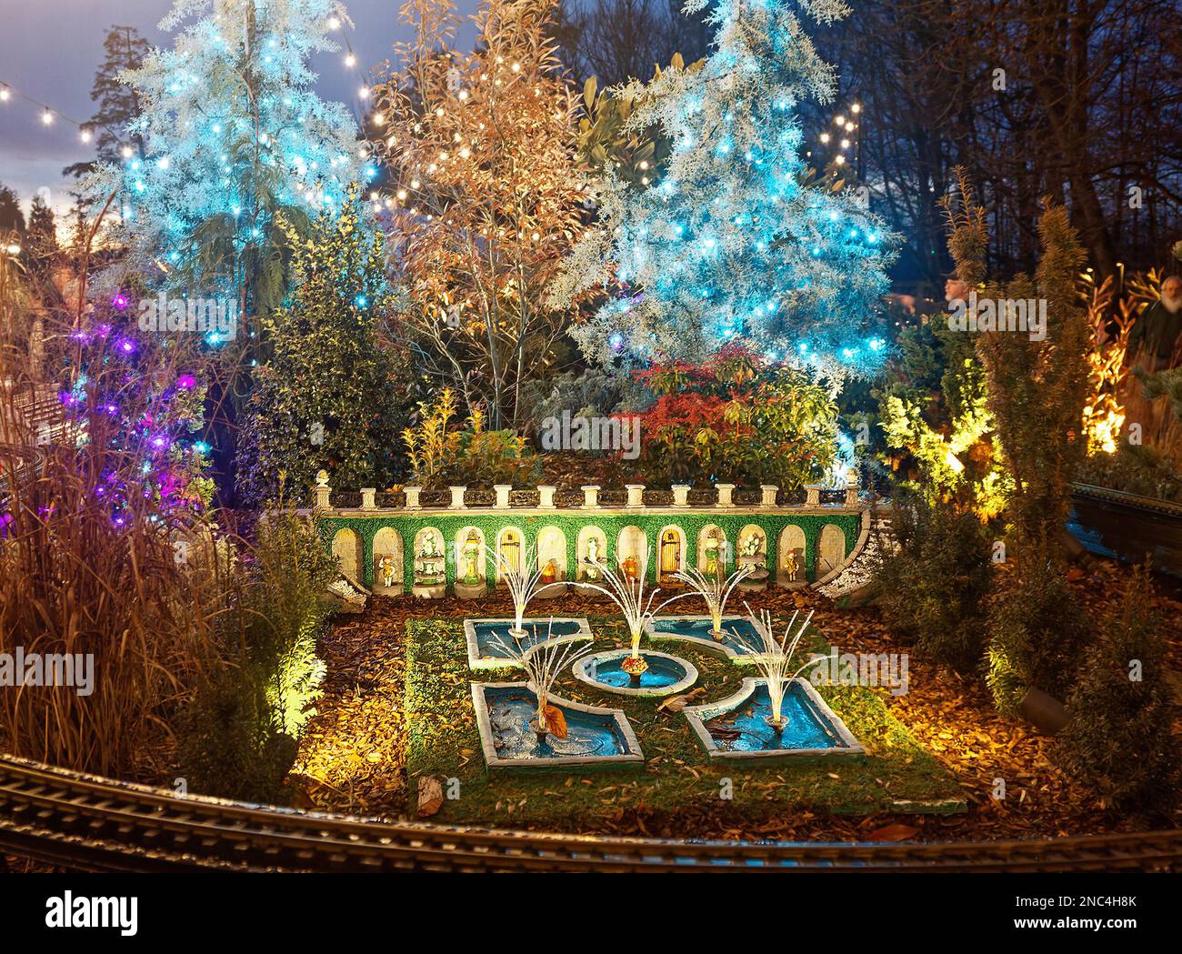 miniature train display, fountains, garden, lighted trees, track