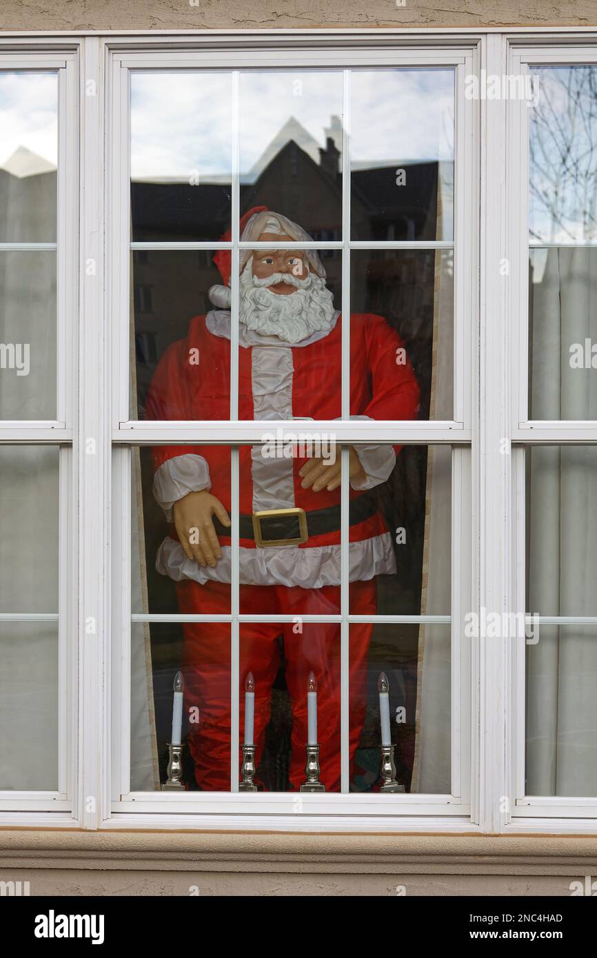 large Santa figure, standing in window, 4 candles, Christmas, holiday decoration, impressive, red, white, PR Stock Photo