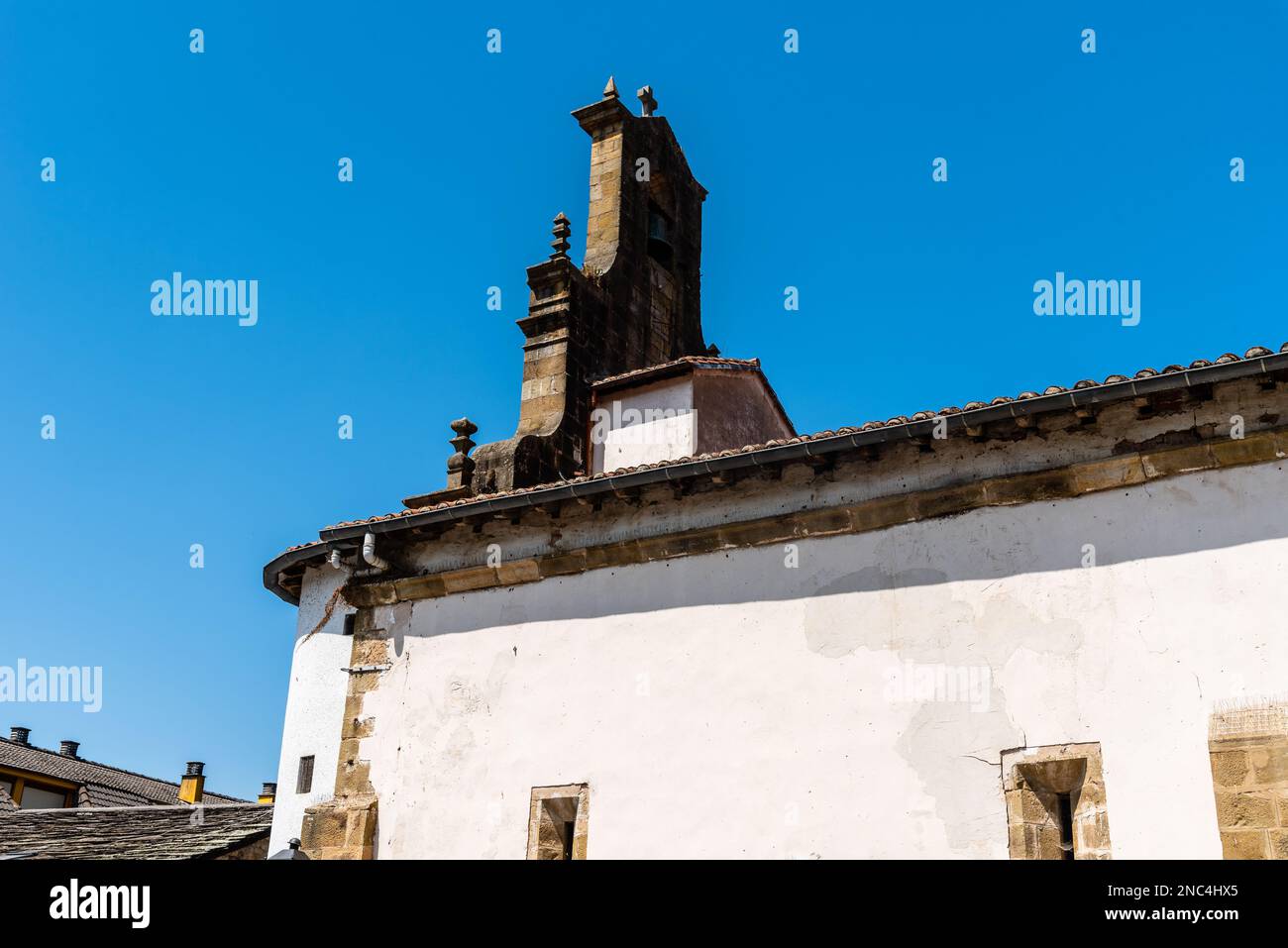Picturesque church in the village of Vega del Pas in Cantabria, Spain. Sunny day of summer, exterior view against blue sky Stock Photo