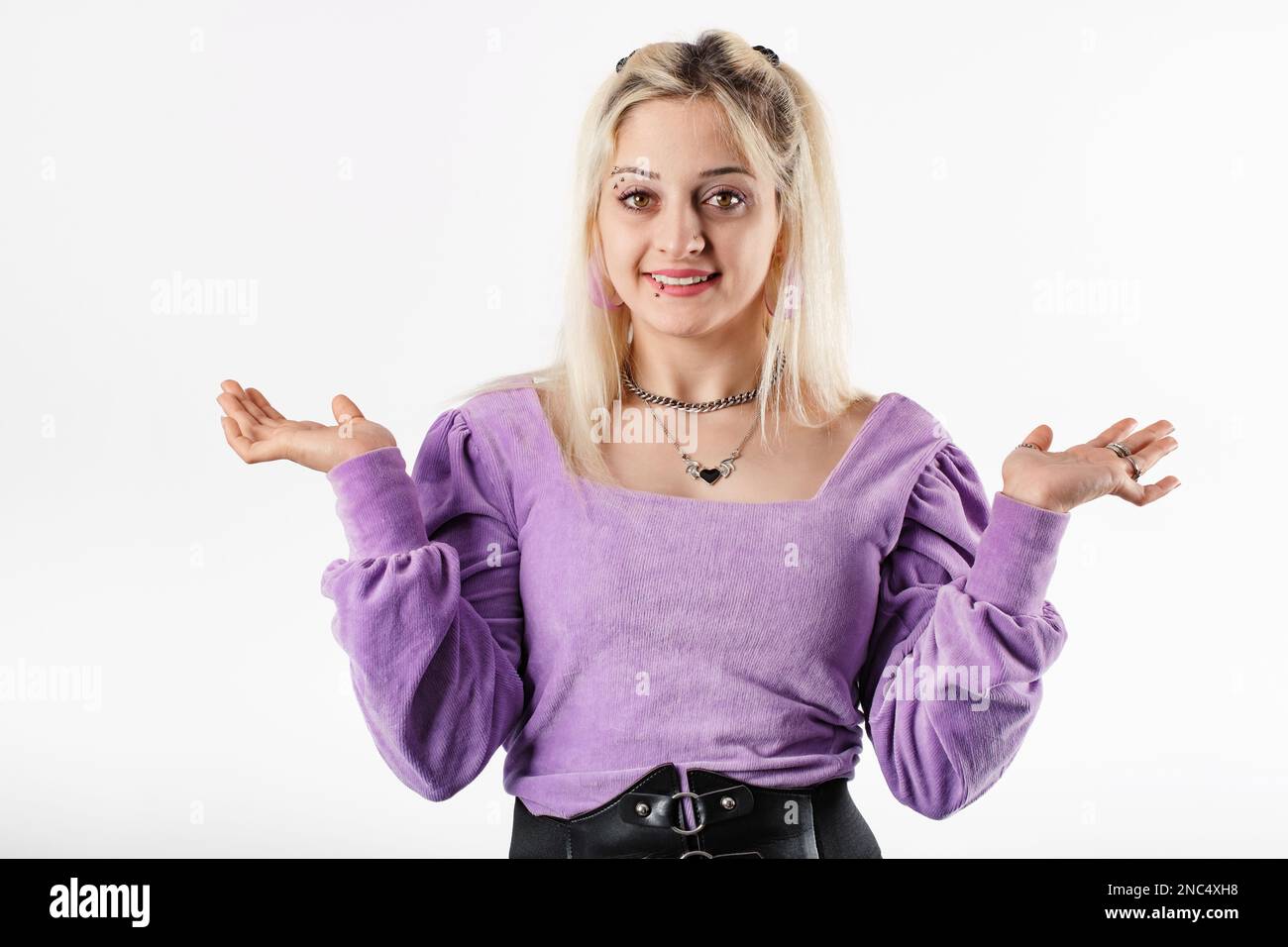 Happy Blonde Woman Wearing Blouse Standing Isolated Over White Background Arms At Sides 