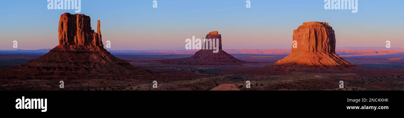 Monument Valley at sunset, with soft purple tones behind the highly texture buttes.  Peaceful and timeless. Stock Photo