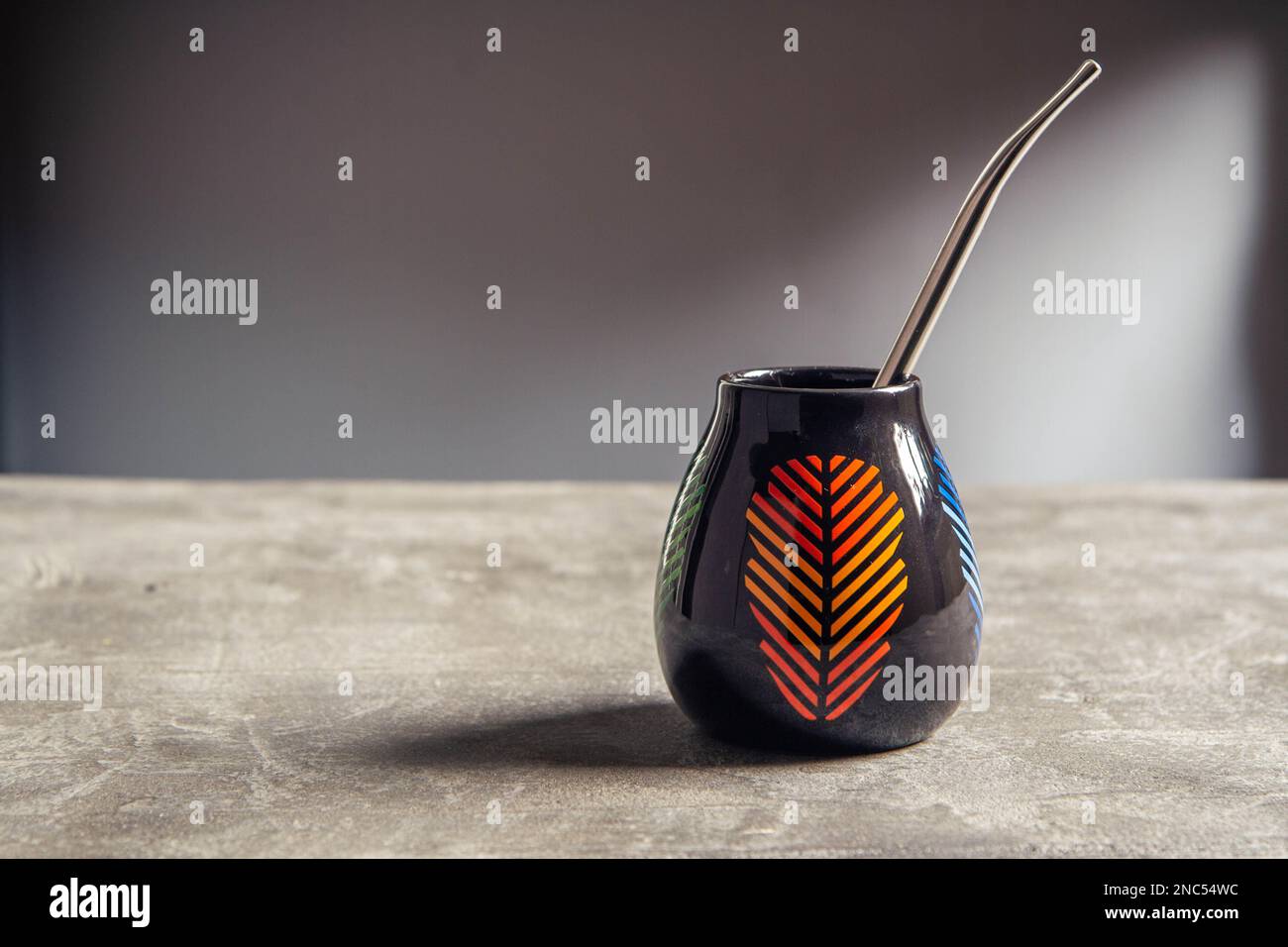 pretty shiny ceramic yerba mate cup, with orange leaf design and metal