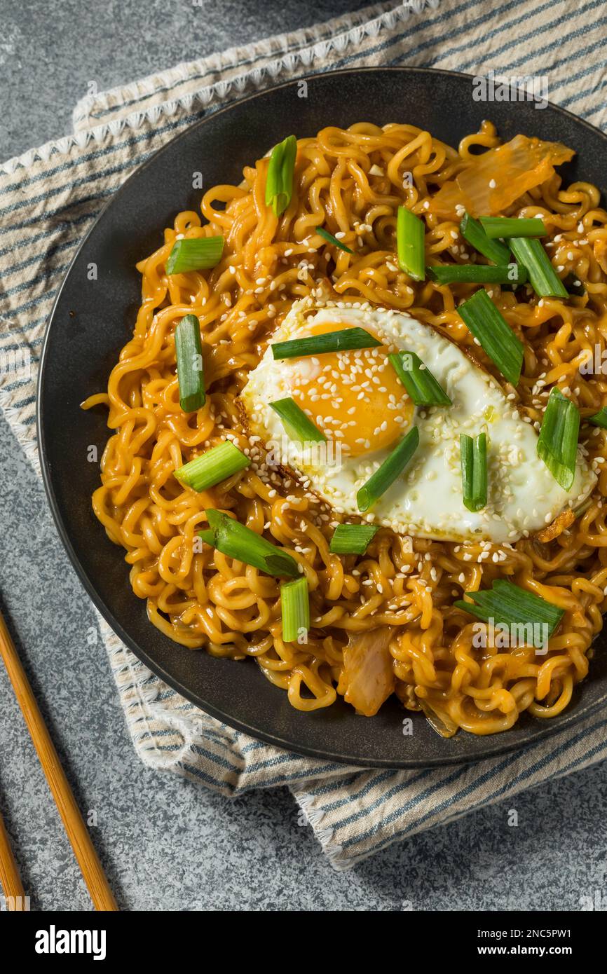 Korean Cheesy Kimchi Noodles with Soy Sauce and an Egg Stock Photo