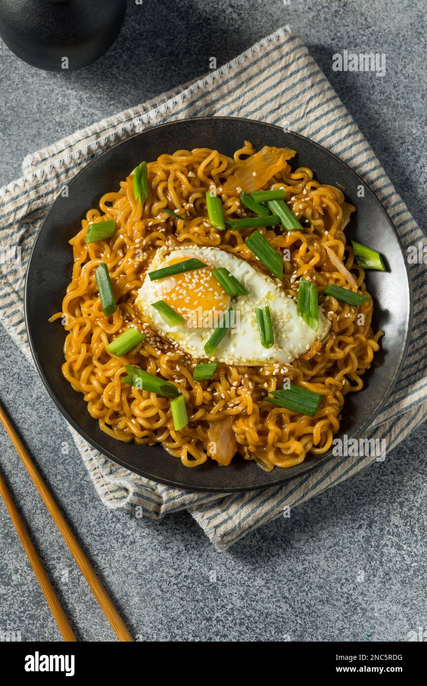 Korean Cheesy Kimchi Noodles with Soy Sauce and an Egg Stock Photo Alamy