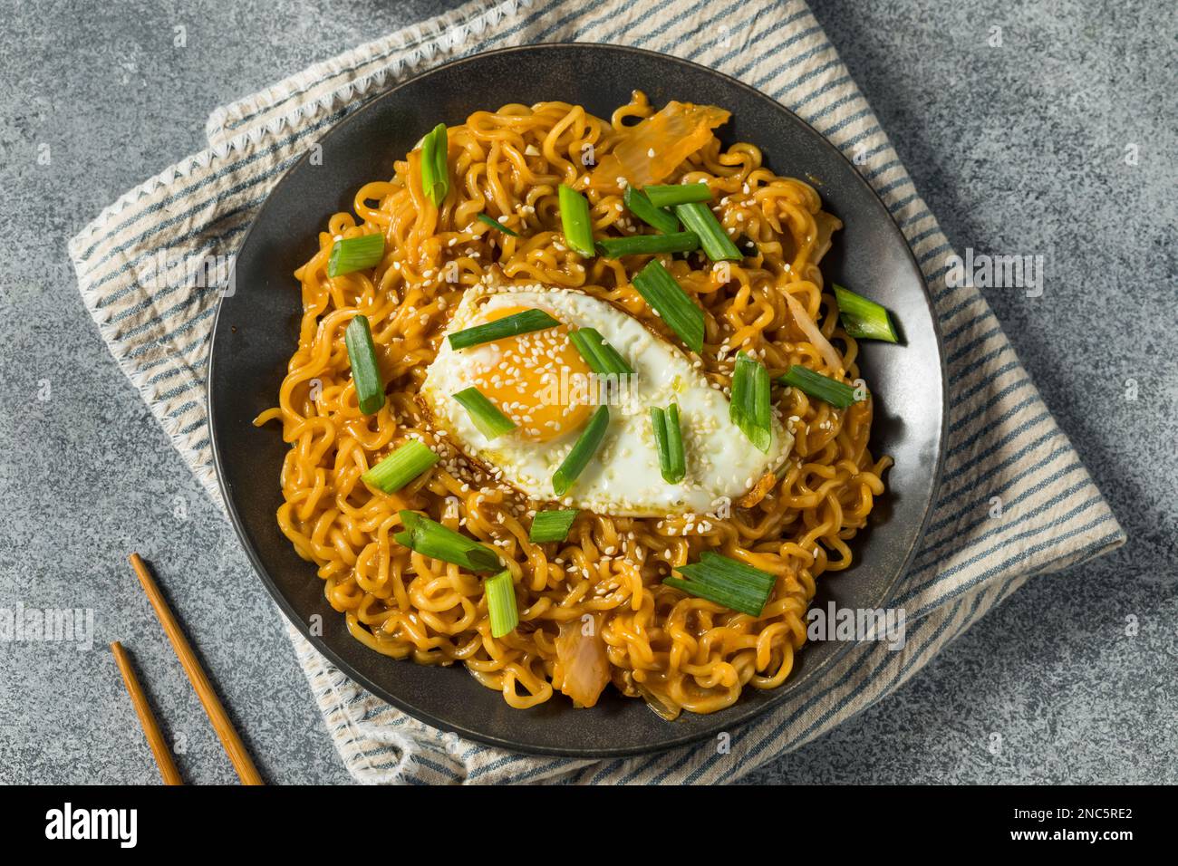 Korean Cheesy Kimchi Noodles with Soy Sauce and an Egg Stock Photo