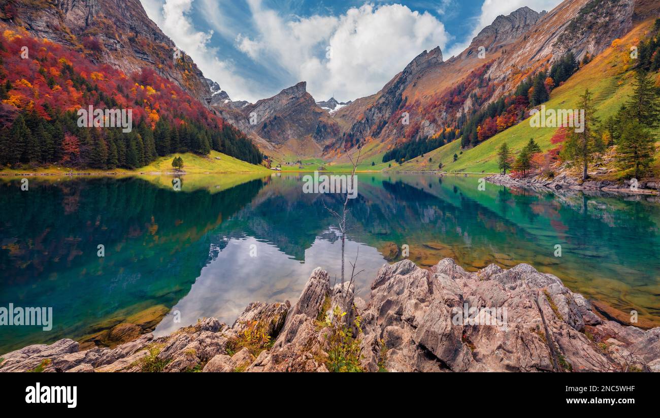 Beautiful autumn scenery. Amazing morning view of Swiss Alps. Santis peak reflected in the calm surface of pure water of lake. Unbelievable autumn sce Stock Photo