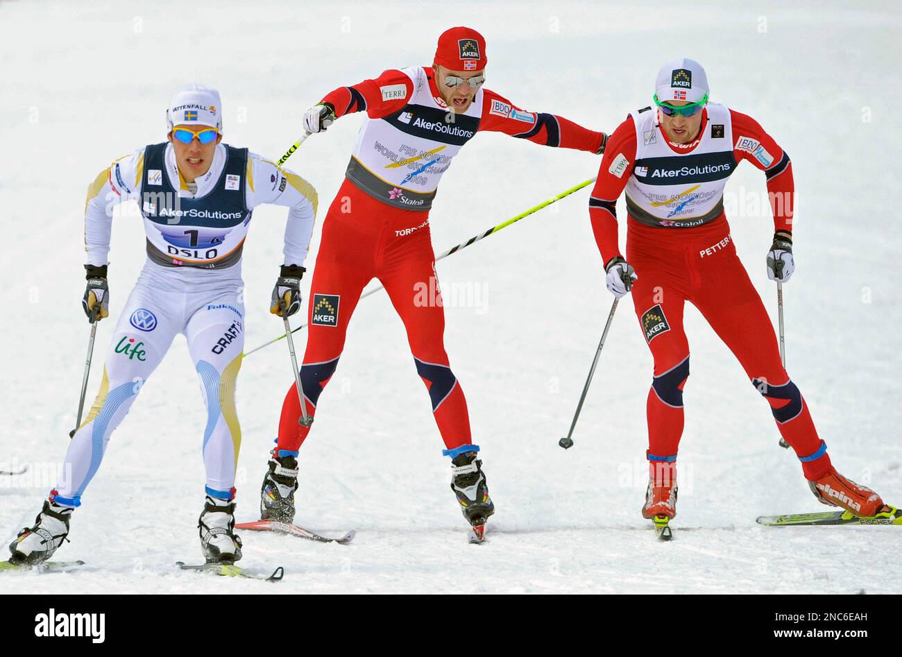 Norway's Petter Northug, right, takes over from his teammate Tord Asle ...