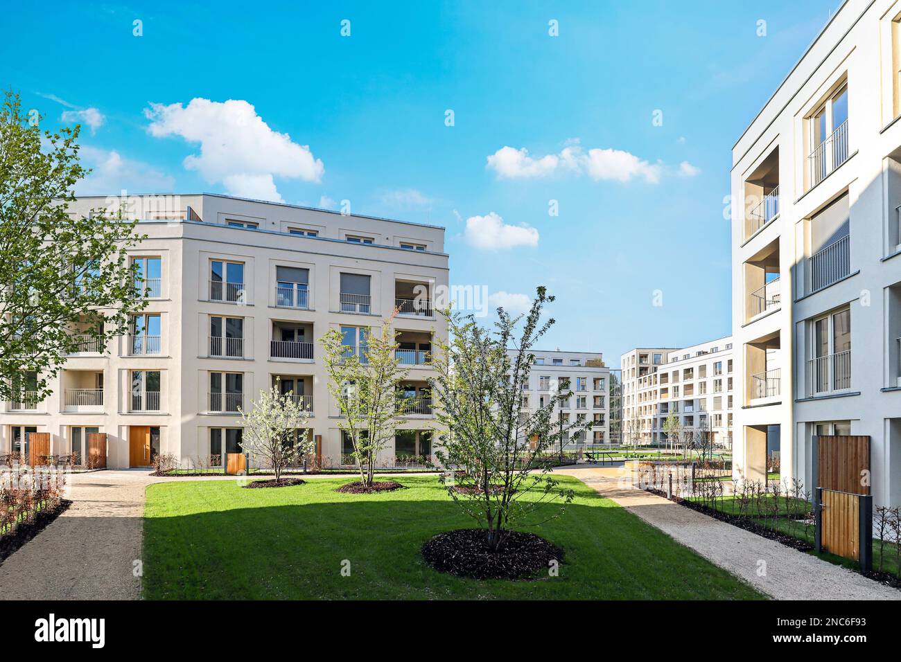 Residential area with ecological and sustainable green residential buildings, low-energy houses with apartments and green courtyard Stock Photo