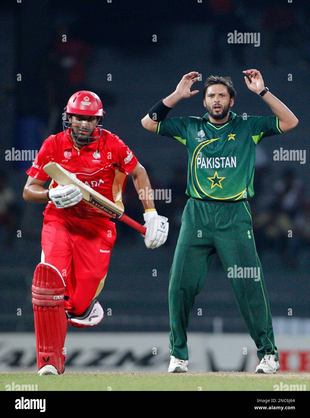 Pakistan's captain Shahid Afridi, right, reacts as Canada's batsman