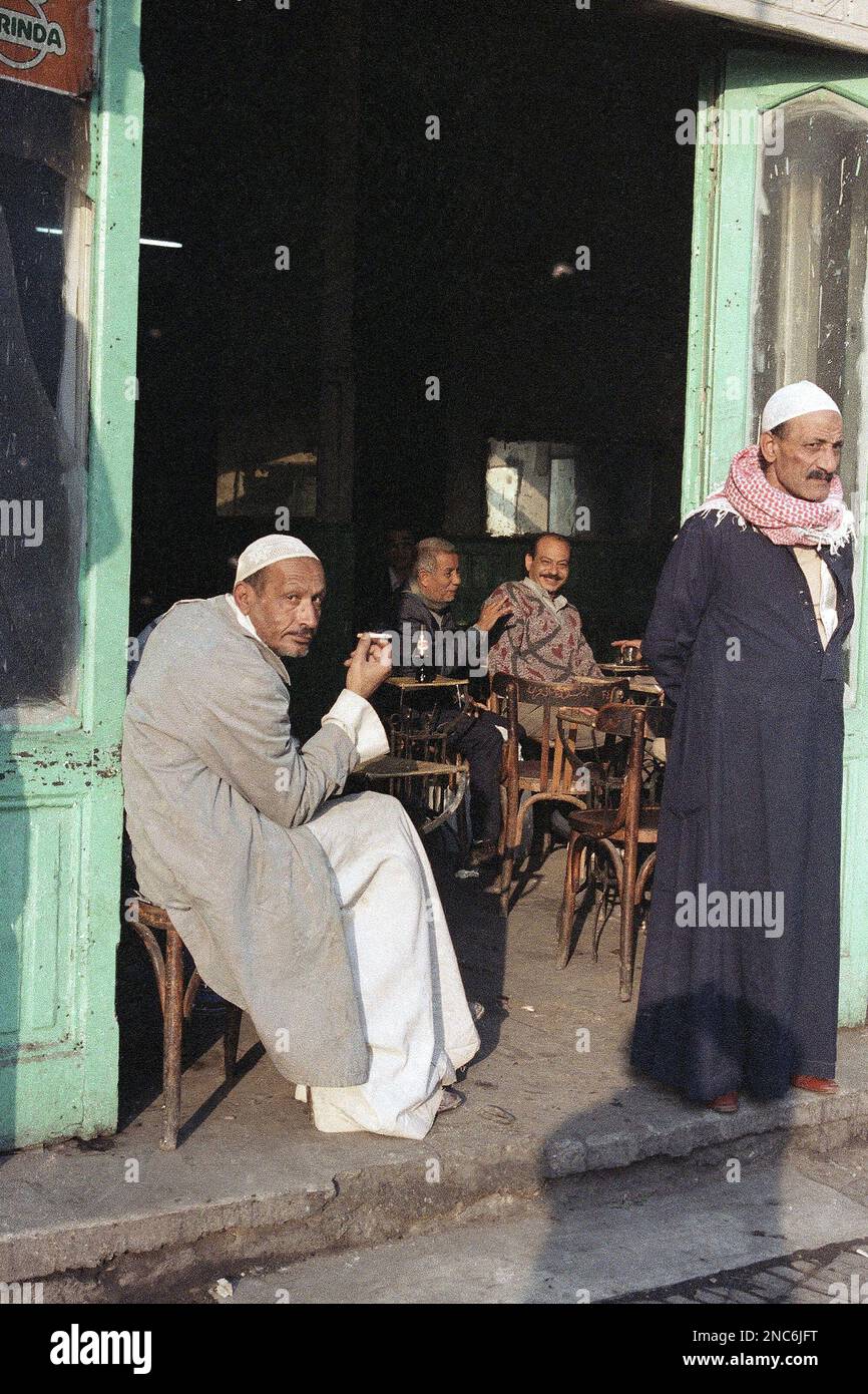 An Egyptian man passes the time in a Cairo café near the ancient Al ...