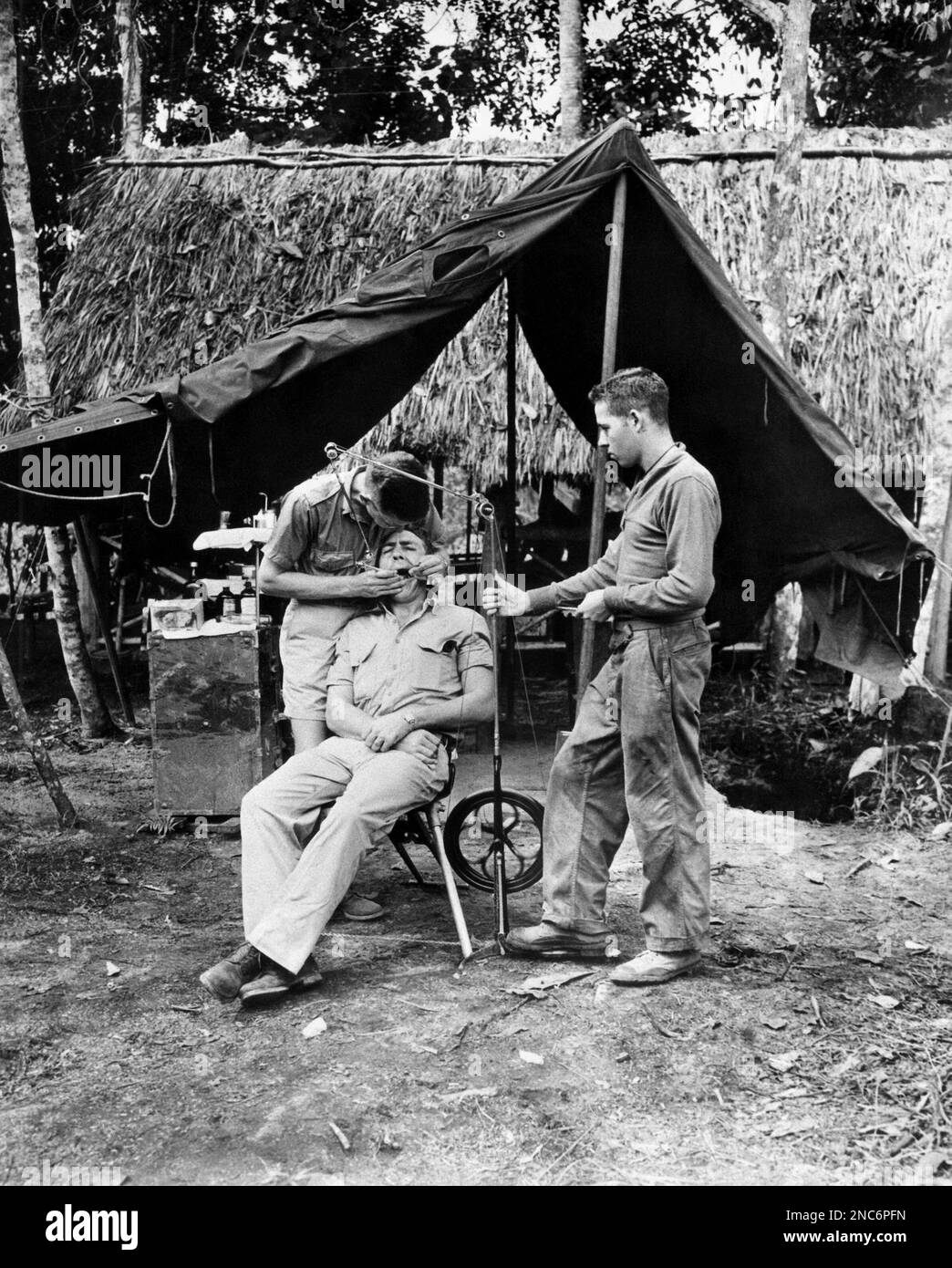 First Lt. (Dentist) W.A. Reiter of Meltcher, Iowa, works on a tooth of
