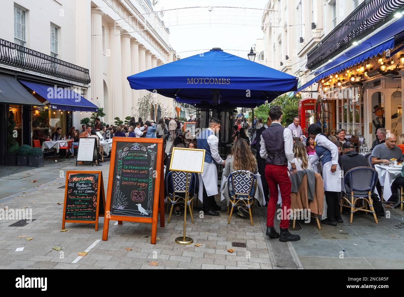 People dining in restaurants on Street in Belgravia, London